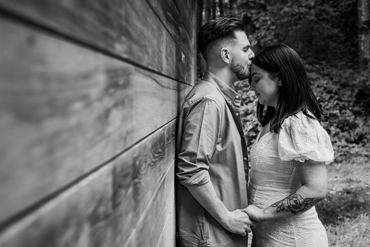 Couple holding hands on woodland walk in Staffordshire