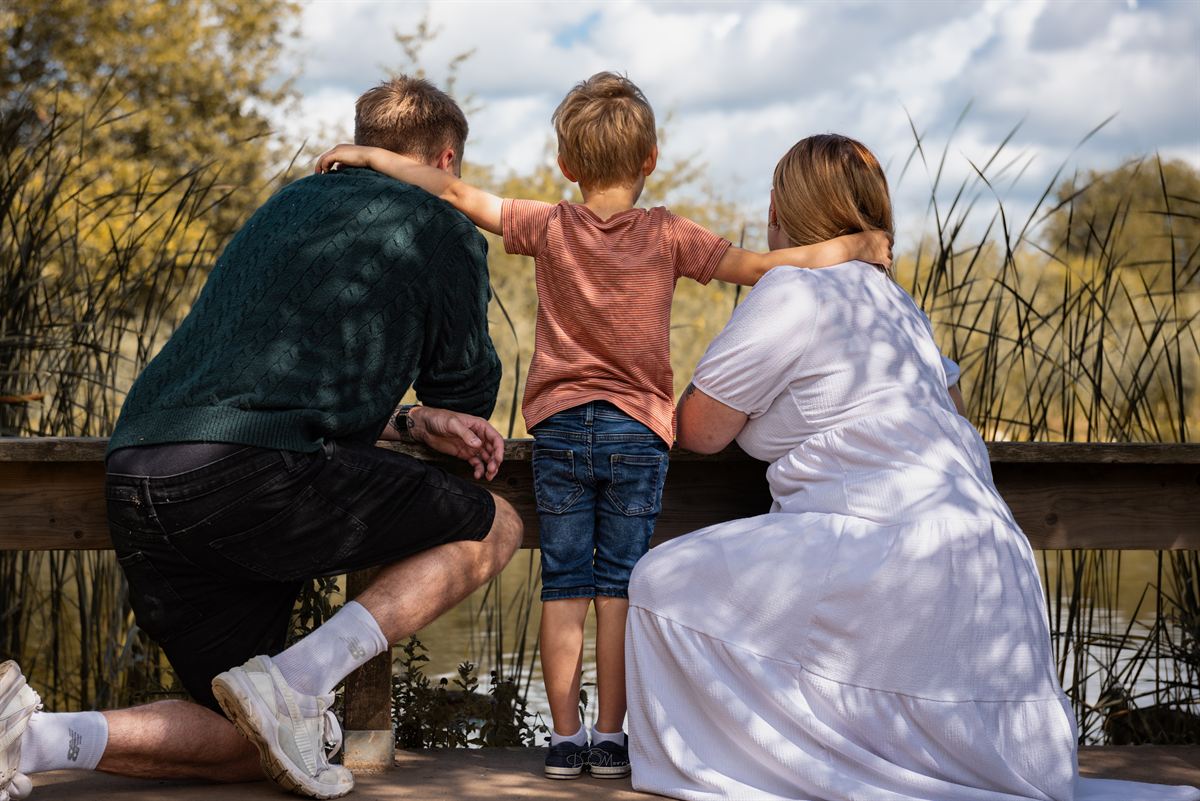 Child picking wildflowers during Staffordshire family session